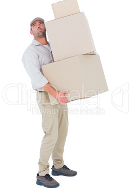 Tired delivery man carrying stack boxes