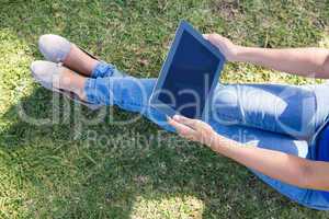 Woman using tablet in park