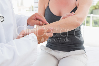 Doctor examining his patient arm