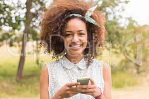 Happy young woman using smartphone