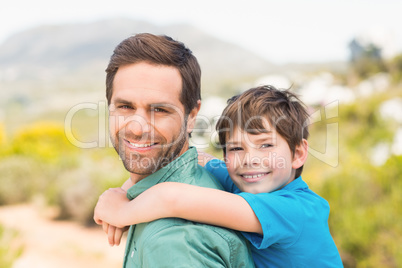 Father and son hiking through mountains