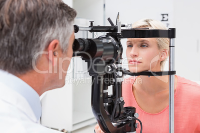 Optometrist examining blonde woman