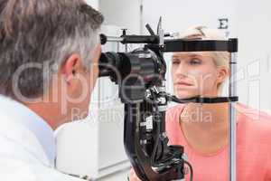 Optometrist examining blonde woman