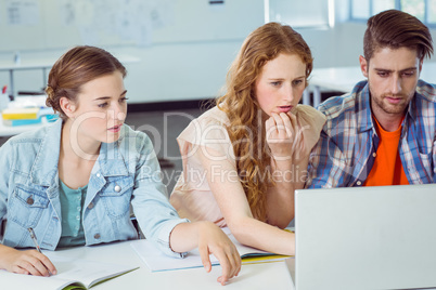 Fashion students looking at laptop