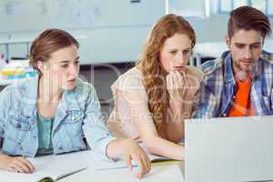 Fashion students looking at laptop