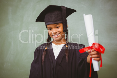 Little girl in graduation robe holding diploma