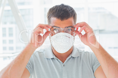 Confident handyman wearing protective eyewear and mask