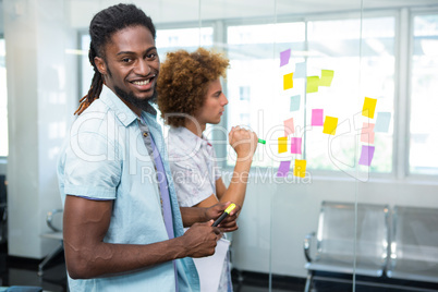 Creative team looking at adhesive notes