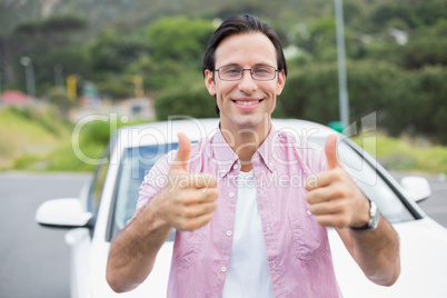 Man smiling at camera showing thumbs up