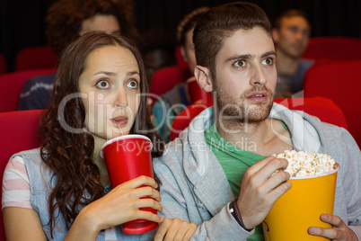 Young couple watching a film