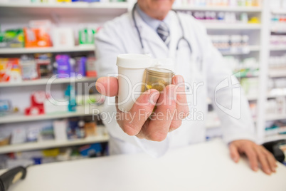 Pharmacist presenting medications on his hand