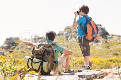 Father and son hiking through mountains