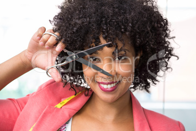 Female fashion designer holding scissors
