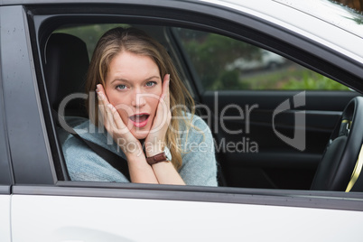Shocked woman sitting in drivers seat