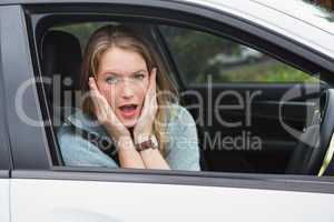 Shocked woman sitting in drivers seat