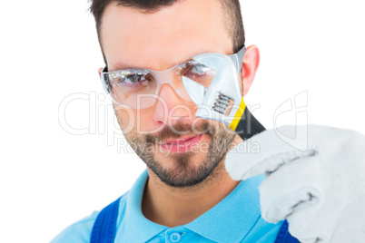 Repairman looking through adjustable wrench