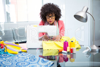 Fashion designer using sewing machine