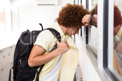 Tensed young man in office corridor