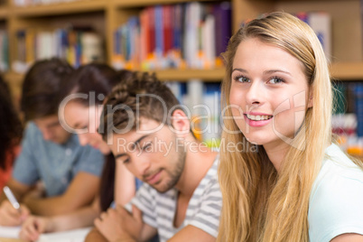 College students doing homework in library