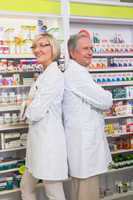 Pharmacist with his colleague standing with arms crossed