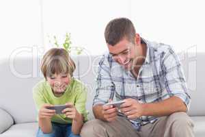 Father and son playing games on mobile phone