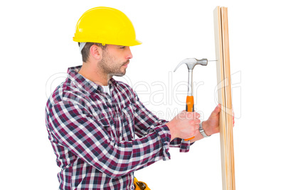 Handyman using hammer on wood