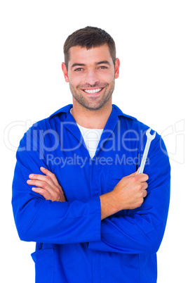 Smiling male mechanic holding spanner