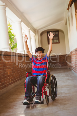 Boy in wheelchair in school corridor