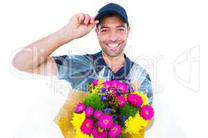 Happy delivery man holding bouquet