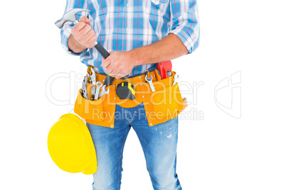 Midsection of manual worker holding hammer