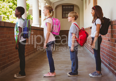 School kids standing in school corridor