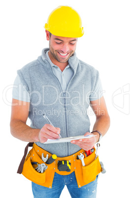 Smiling repairman writing on clipboard