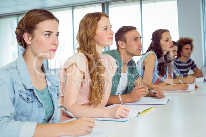 Fashion students taking notes in class Fashion students taking notes in class