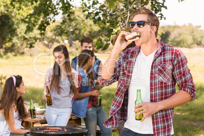 Happy friends in the park having barbecue