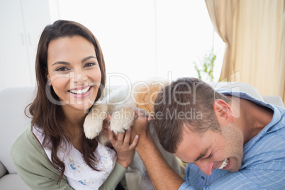 Couple with puppy at home