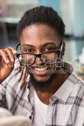 Happy male fashion designer holding eye glasses