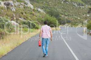 Man walking away holding petrolcan
