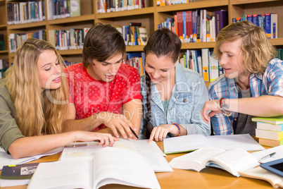 College students doing homework in library