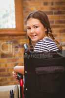 Girl sitting in wheelchair in school