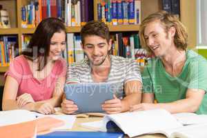 College students using digital tablet in library