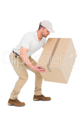 Delivery man crouching while picking cardboard box