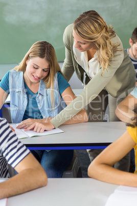 Teacher helping student in class