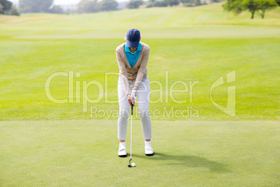 Female golfer putting her ball