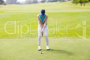 Female golfer putting her ball