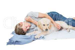 Boy sleeping with cute dog on blanket