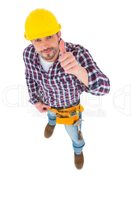 Smiling handyman with thumbs up