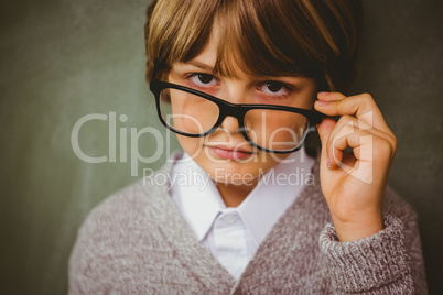 Cute little boy holding glasses