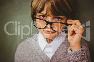 Cute little boy holding glasses