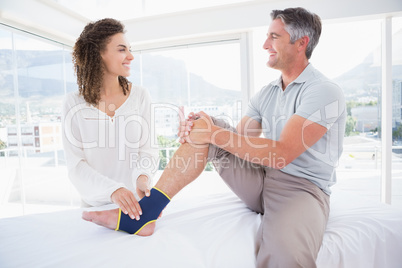 Doctor examining her patient foot