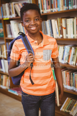 Portrait of happy cute boy in library